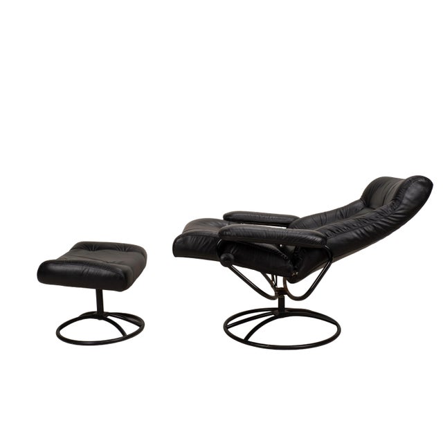Comfortable and beautifully designed vintage Ekornes Stressless recliner and matching ottoman in black leather, made in...