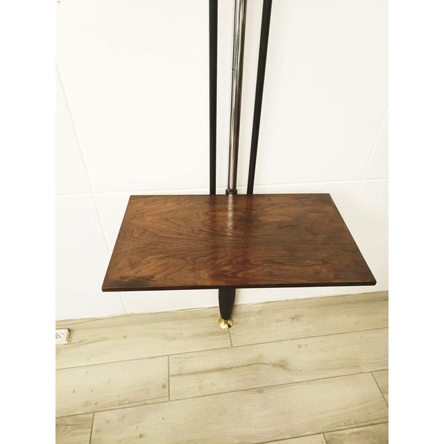 A floor-to-ceiling steel and metal bookcase with three wooden shelves, designed by Carlo Hauner & Martin Eisler for Forma...
