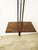 A floor-to-ceiling steel and metal bookcase with three wooden shelves, designed by Carlo Hauner & Martin Eisler for Forma...