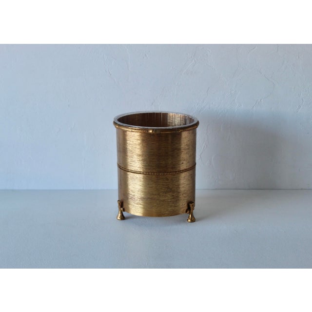 Vintage Mid Century Hollywood Regency Glam Bamboo themed wastebasket footed and original clear plastic liner. This...