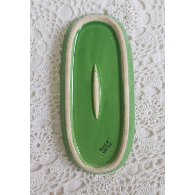A 1950s majolica corn spoon rest, measuring 8 ¾” l x 4" x 1". Originally intended as a serving dish, it is the perfect...