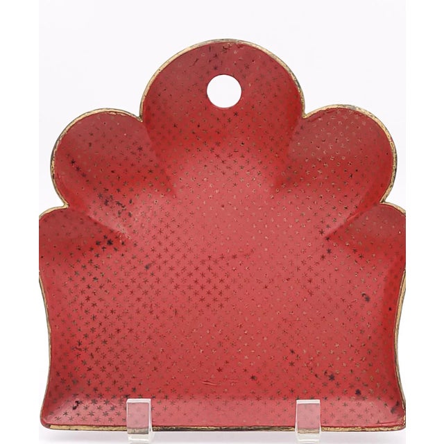 A 19th-century French crumber decorated with gold stars on a Chinese red lacquer background.