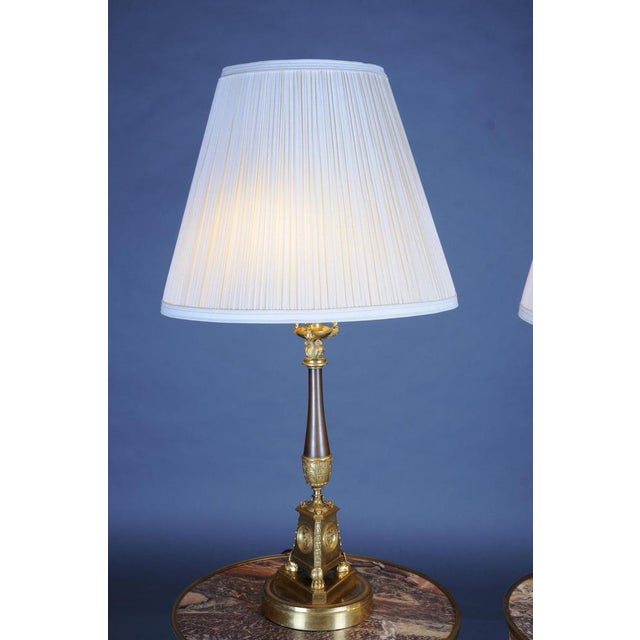 Pair (2) Empire bronze table candlesticks around 1805, Paris, fire gilded. Pair (2) Empire bronze table candlesticks...