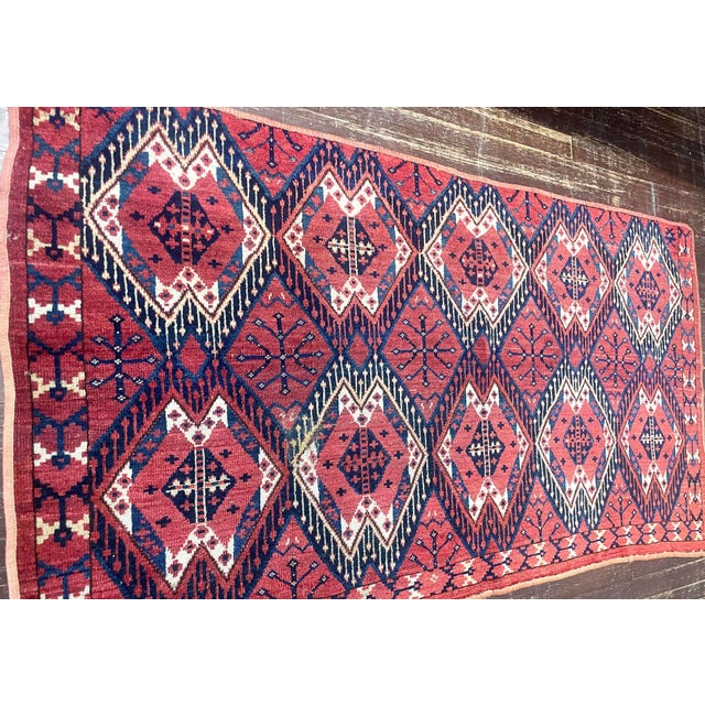 An attractive antique Yomud Turkoman rug fragment featuring an all-over lattice of large hooked diamond medallions set...