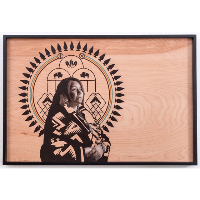 This artwork features a striking portrait of a figure draped in a patterned blanket, set against a warm wooden background...
