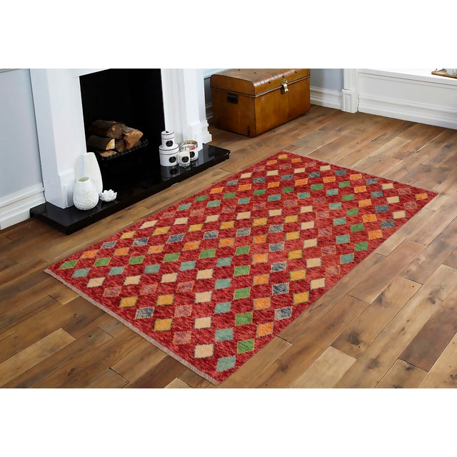 This stunning hand-knotted Afghan Balouchi rug is a captivating addition to any decor. Crafted by skilled artisans, it...