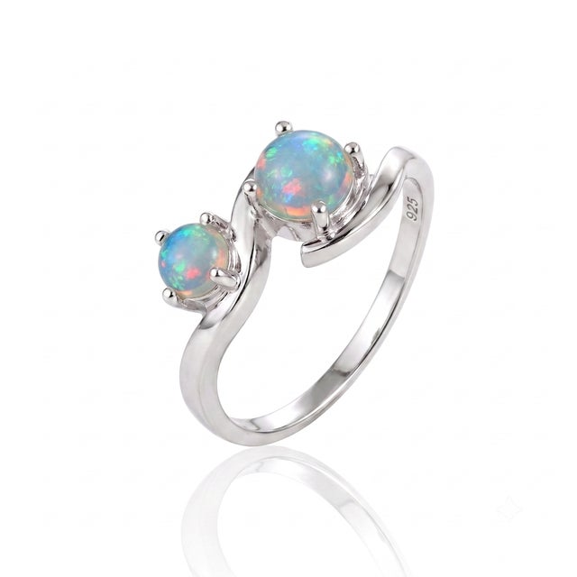 With a captivating bypass swirl, this delicate ring lets twin stones interact with light from every angle, creating a...