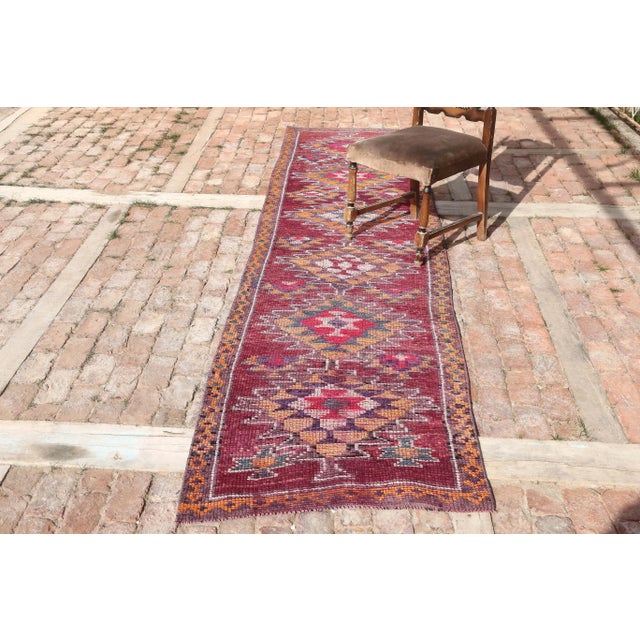 Vintage Herki Hand-Knotted Hallway Runner Rug is a semi-Vintage rug. '50s Eastern region of Turkey's unique rug is...