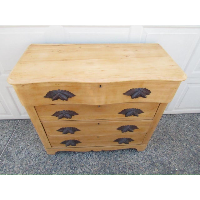 Antique American scrubbed pine cottage style dresser, c.1880 Having a serpentine molded top and upper drawer, with three...