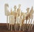19th century collection of french carved bone game pieces. Displayed on primative wood stool or stand. Carved horses,...