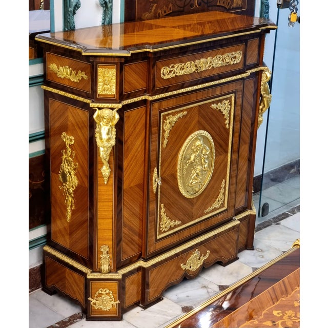 Bring sophisticated European elegance to your interior with this grand French Louis XVI-inspired cabinet, featuring a rich...