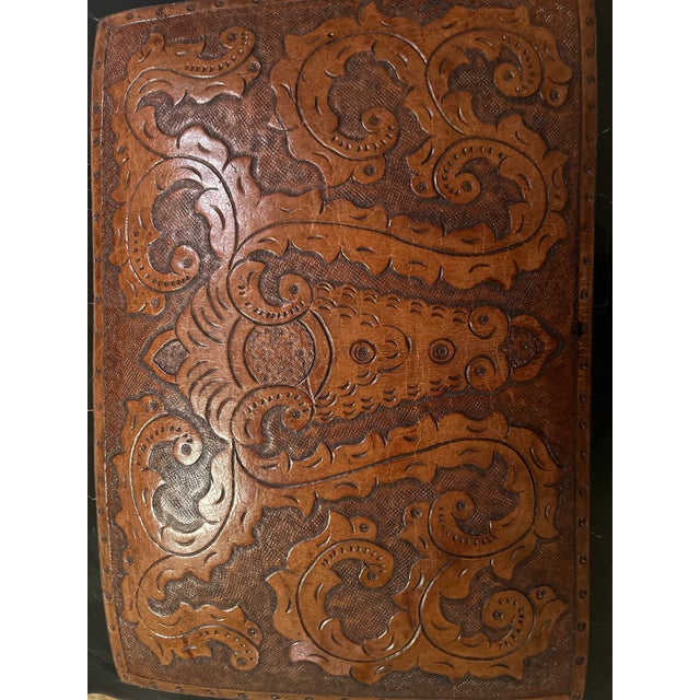 An intricately hand-tooled seat in dark chocolate and antique brown leathers and nailhead trim. Stool is crafted from...