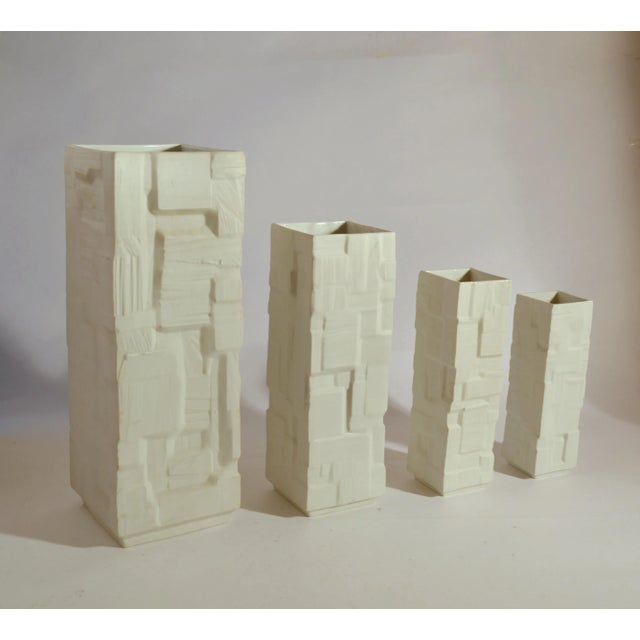 Set of four white porcelain square vases in descending heights with relief surface, Germany, 1960's. Measures: Heights...