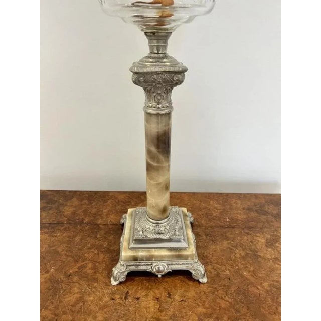 Antique Edwardian quality oil lamp having a quality oil lamp with a globular shade above a clear glass font above a...