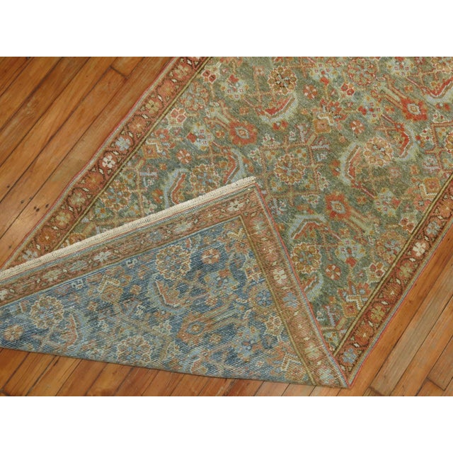 Narrow and Long Antique Persian Malayer Runner circa 1920. All over herati design with a green abrashed field with...