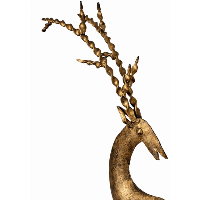 A sculptural brass deer by Hosley, featuring dramatic twisted antlers and a timeworn patina. Produced by the Chicago-based...