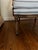 Medallion Back: Features an oval-shaped, deep button-tufted backrest.Frame Style: The exposed dark walnut or mahogany wood...