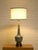 A striking vintage Mid-Century Modern table lamp featuring an elongated sculptural ceramic body covered in an intricate...