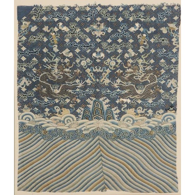 Qing dynasty, silk tapestry of two five clawed dragons with lotus flowers and clouds over [lishui] border, torn edges,...