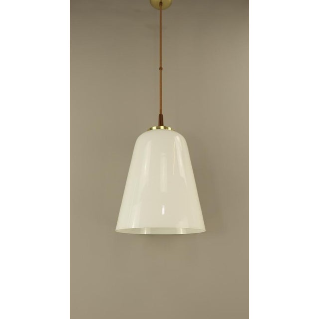 Extravagant lamp with large opal shade. the brass rod is wrapped in fine silk dimensions of the lampshade: diameter 38 cm,...