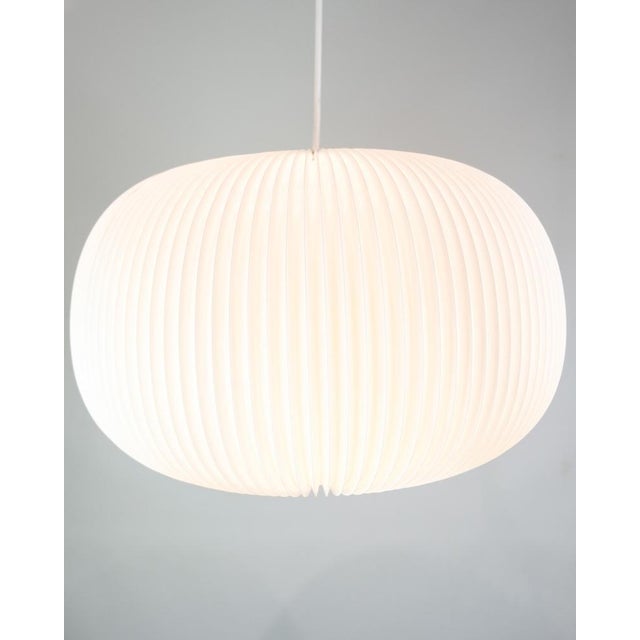 This ceiling lamp, part of the 132 Lamella Series, is an example of modern and elegant lighting design created by Hallgeir...