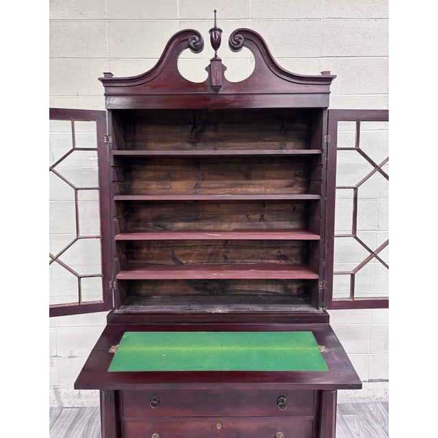 This is a gorgeous antique Empire flame mahogany secretary desk and bookcase with Georgian-influenced swan-neck pediment,...
