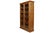 A traditional wooden bookcase made of oak with oak veneers. The solid oak frame supports four oak veneered shelves behind...