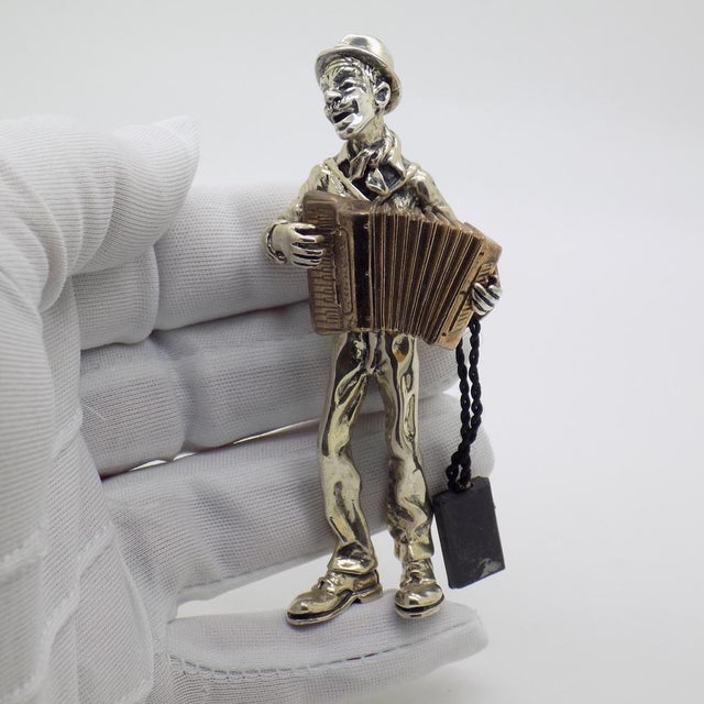 Vintage statement sculpture depicting an accordion player, handmade in italy between the 1980s and 1990s in genuine solid...