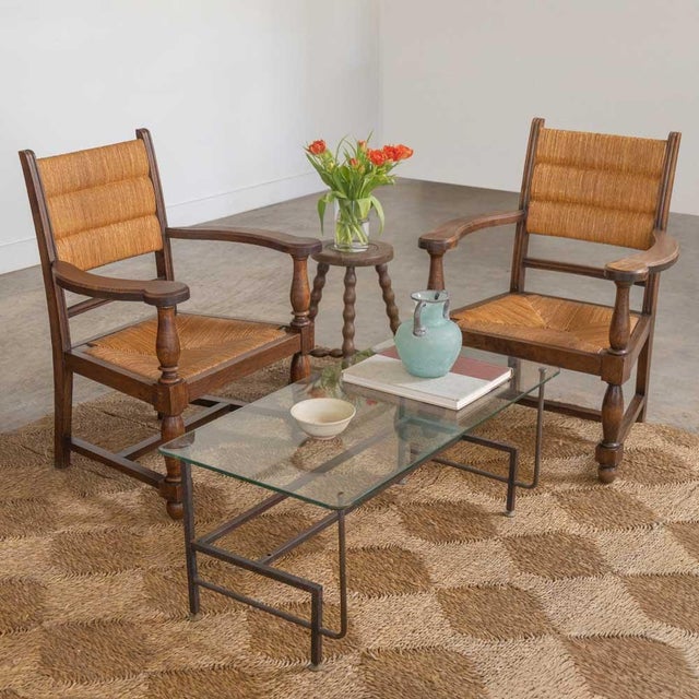 Incredible pair of carved wood armchairs by Charles Dudouyt from France, 1940s. Beautiful woven rush back and seat....