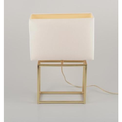 Designer table lamp in brass with a white fabric shade. Modernist and sleek design. Late 20th century. In perfect...