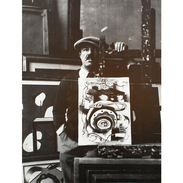 An excellent black and white reproduction of Photograph of Fernand Leger With his painting "Composition" in his studio....