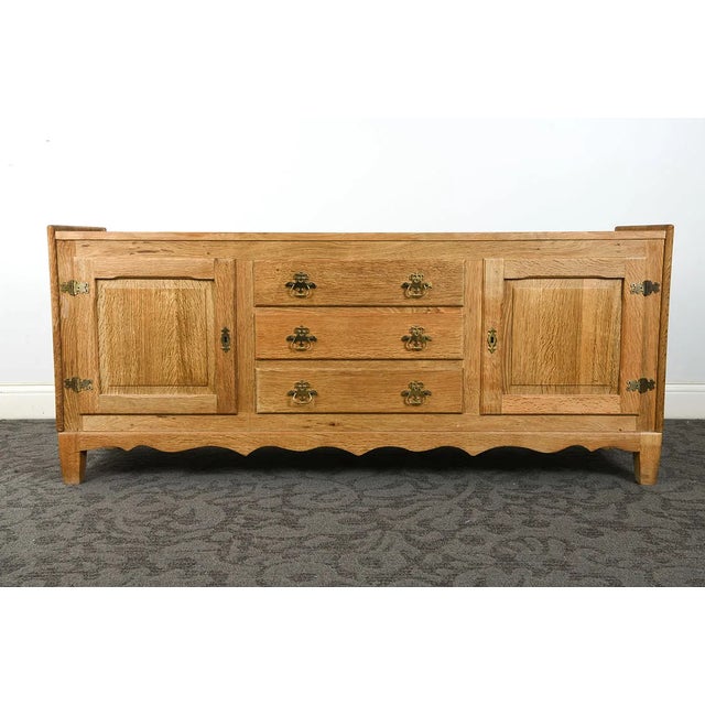 Vintage Danish oak sideboard from the 1970s, in the style of Henning Kjærnulf. Featuring beautifully figured oak grain,...