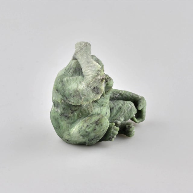Stone-cut miniature from jade "Orangutan". Depicts an anxious monkey scratching the back of its head. Weight: 341 gr.