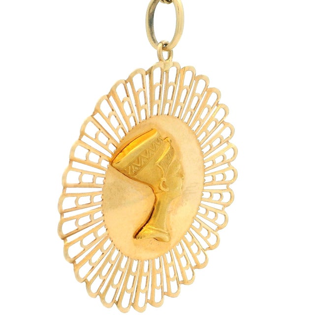 Vintage Italian Egyptian Revival pendant crafted in solid 18K yellow gold. This striking medallion features a sculpted...