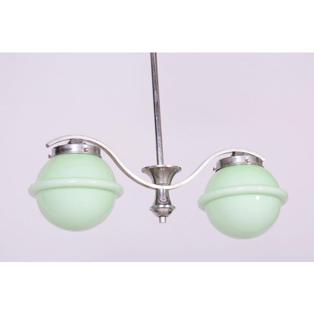 This chandelier is a prime example of functionalist elegance and the Bauhaus movement in 1930s Czechoslovakia. Its design...