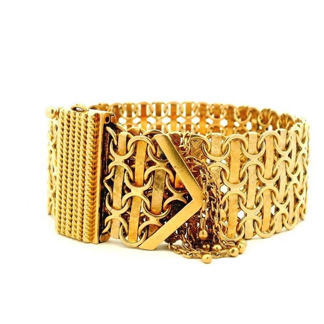 An impressive vintage Italian bracelet crafted in solid 18 karat yellow gold, featuring a bold openwork design and...