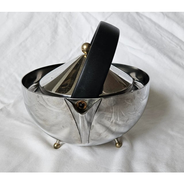1980s Carsten Jorgensen for Bodum Stainless Steel Tea Pot Incredibly stylish tea pot with a curved black wooden handle,...