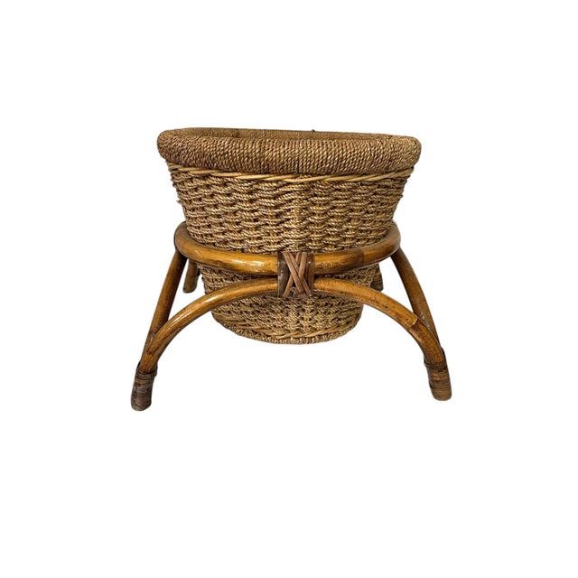 Vintage mid century rattan bamboo planter stand with woven basket planter. Basket is attached to the stand. Measures 16.5"...