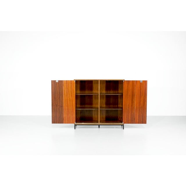 Wooden sideboard mounted on a black metal base (not original). The butterfly doors, along with the key, are a lovely...