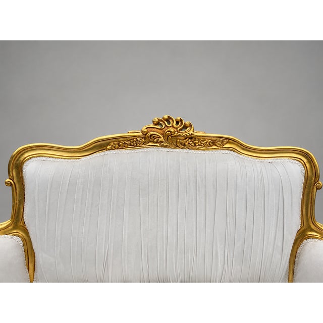 A graceful 1980s French Louis XVI–style settee, crafted with a carved solid beechwood frame and newly upholstered in soft...