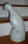 A very large figure of a pigeon or parrot standing on rookwork. White glaze with orange peel surface. Measures 16" tall....