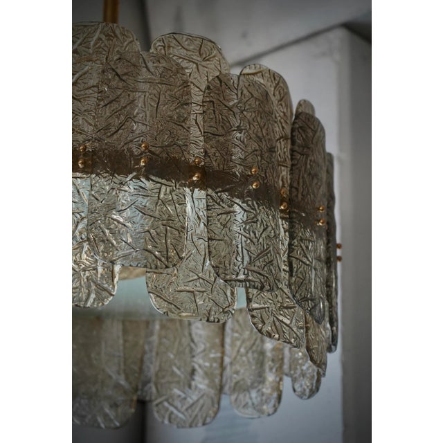 Fantastic round chandelier in Murano glass and polished brass. Note the shape of the smoked Murano glass tiles, very...