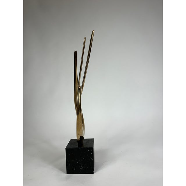 An atract bronze sculpture by Bob Bennett. A modernist touch for the room