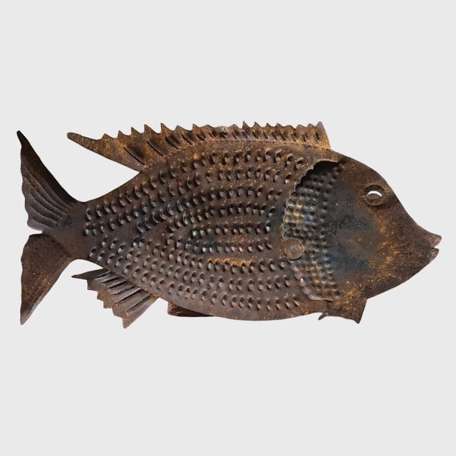 Large Vintage Outsider Cut Metal Fish Sculpture. Cut metal fish sculpture with detailed scale pattern along the body and...