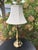 Classic vintage Stiffel table lamp featuring a warm brass-finished metal base with an elegant turned silhouette and tiered...
