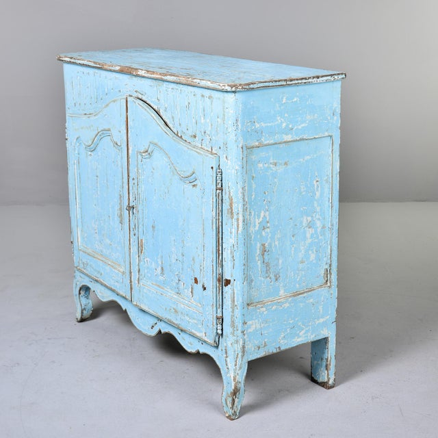 A charming French Provincial buffet in the Louis XV taste, featuring arched and molded double doors, a reeded frieze,...