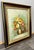 This charming Vintage French oil painting presents a vibrant floral still life, beautifully arranged with warm yellows,...