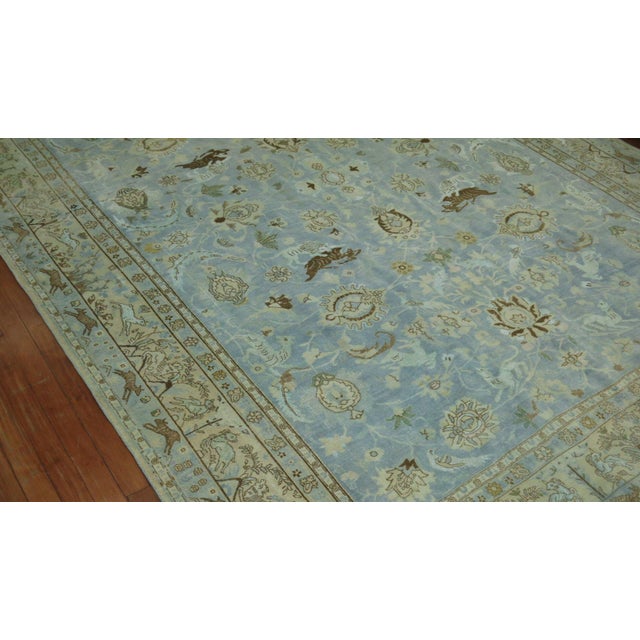 early 20th century Persian Tabriz Pictorial rug in predominant light blue featuring a flurry of animals floating in field...