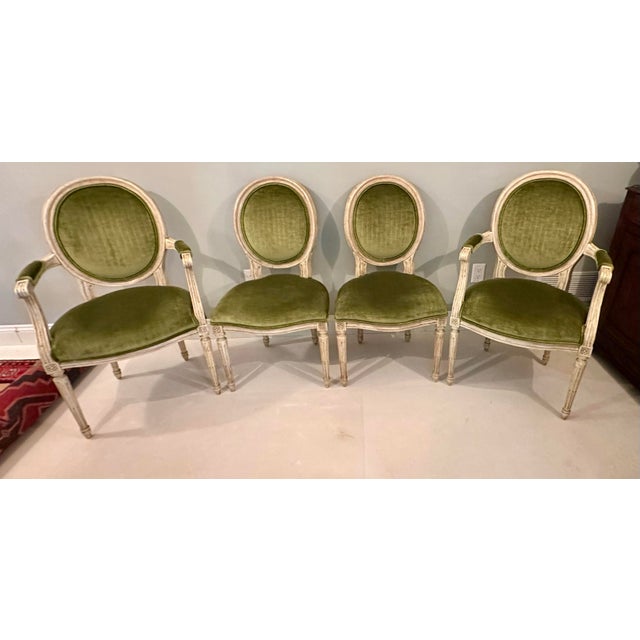 Offered is an elegant set of four Louis XVI-style salon chairs by Baker Furniture, including two armchairs and two side...
