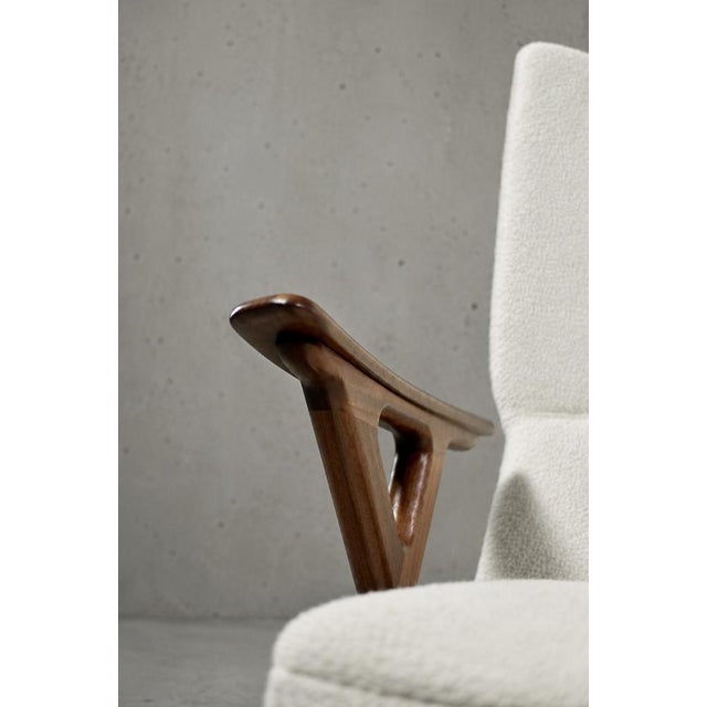 This high lounge chair was manufactured in Norway during the 1960s. The frame is made of teak. Short and wide armrests are...